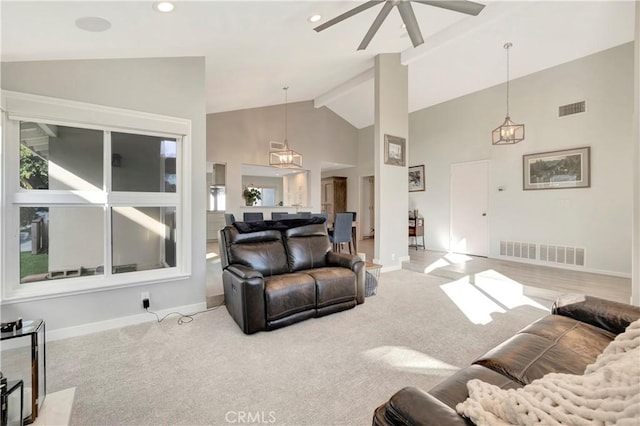 carpeted living room featuring beam ceiling, ceiling fan, and high vaulted ceiling