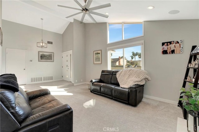 carpeted living room featuring ceiling fan and high vaulted ceiling