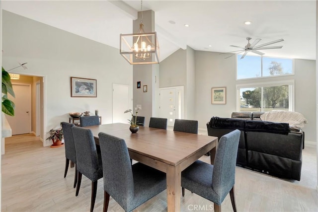 dining area featuring ceiling fan with notable chandelier, high vaulted ceiling, beam ceiling, and light hardwood / wood-style floors