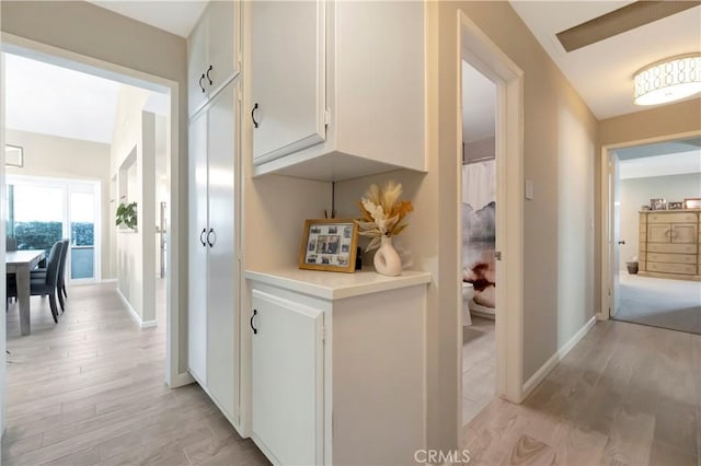 hallway with light hardwood / wood-style floors