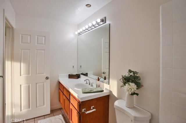 bathroom with vanity, toilet, and tile patterned flooring