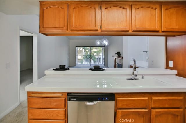 kitchen with sink, light colored carpet, and stainless steel dishwasher