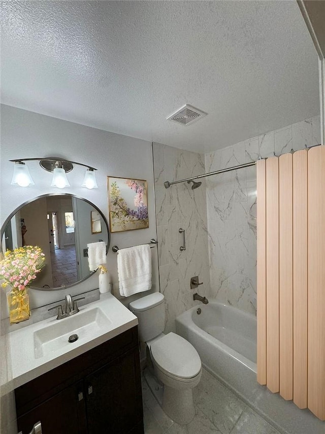 full bathroom with vanity, tiled shower / bath combo, a textured ceiling, and toilet