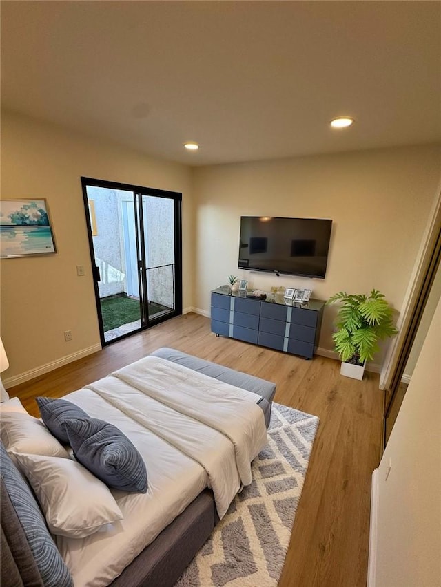 bedroom featuring access to exterior and light hardwood / wood-style floors