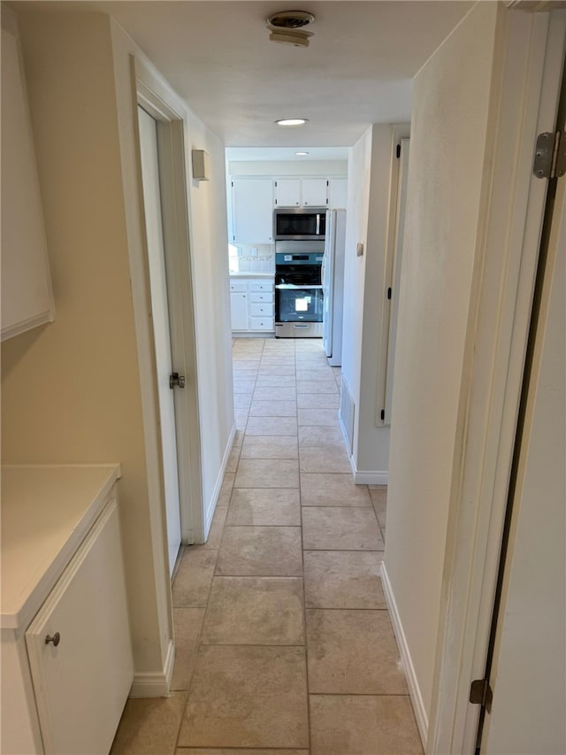 corridor with light tile patterned floors