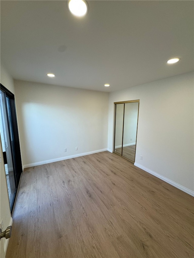 spare room with light hardwood / wood-style floors