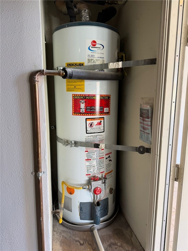 utility room featuring strapped water heater