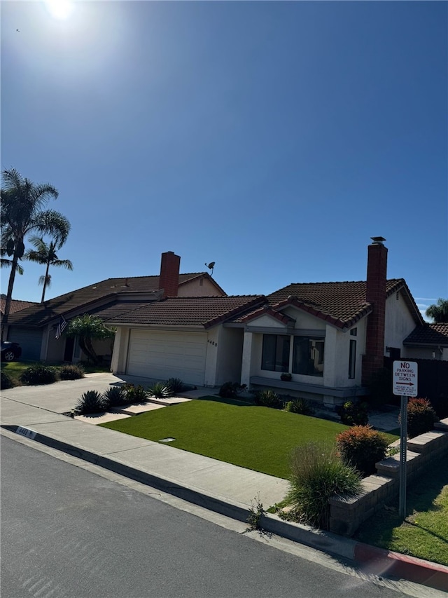 view of front of home featuring a garage and a front yard