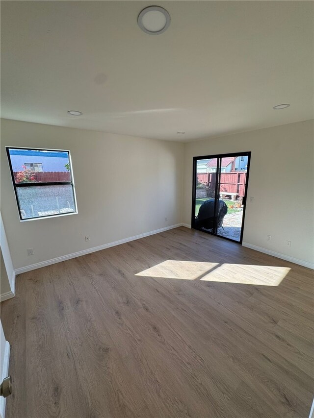 empty room with light hardwood / wood-style floors