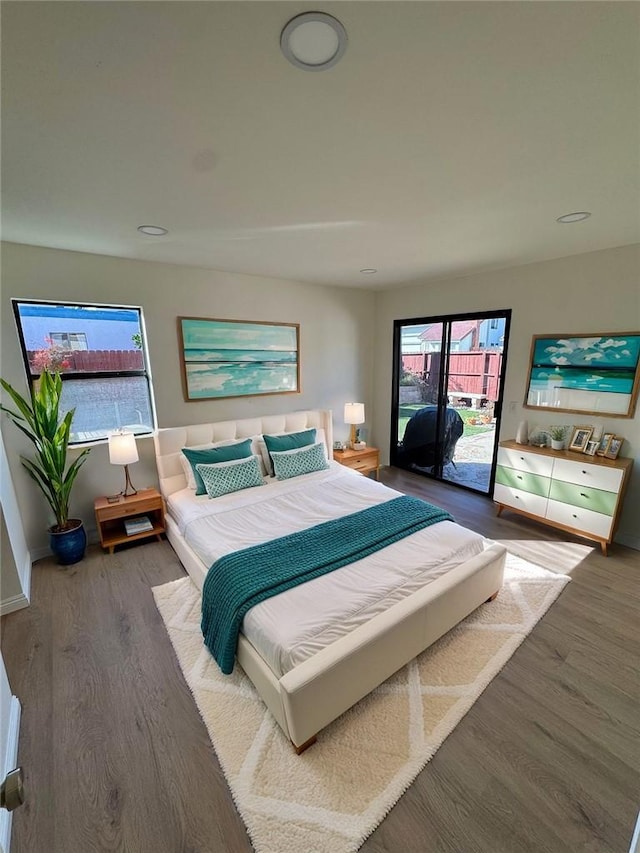 bedroom featuring dark hardwood / wood-style floors and access to outside