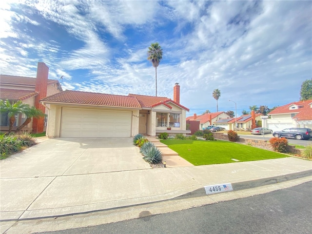 view of front of home featuring a garage and a front yard