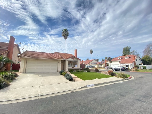 view of front of property with a garage and a front lawn