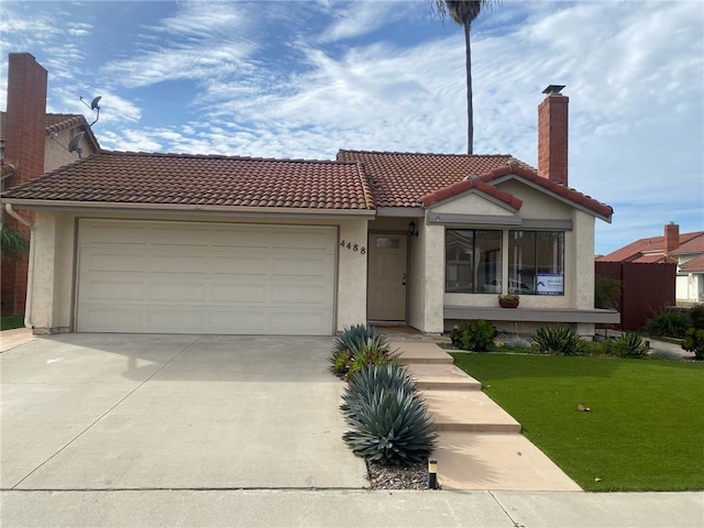 view of front of house featuring a garage and a front lawn