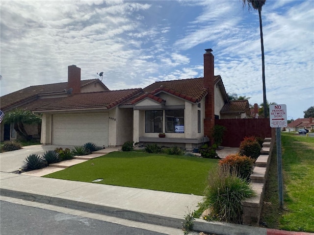 view of front of home featuring a garage and a front lawn