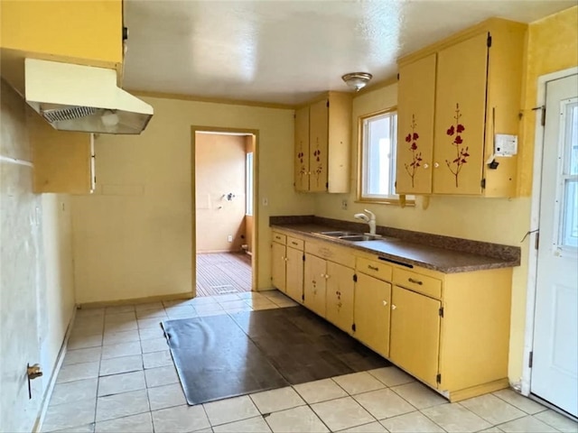 kitchen featuring sink, range hood, and light tile patterned flooring