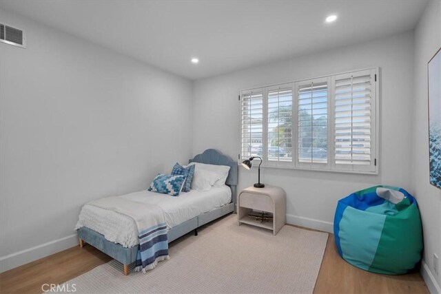 bedroom with hardwood / wood-style floors