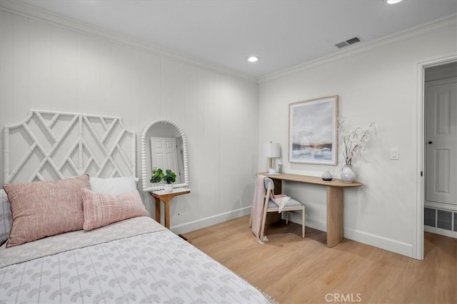 bedroom with ornamental molding and hardwood / wood-style floors