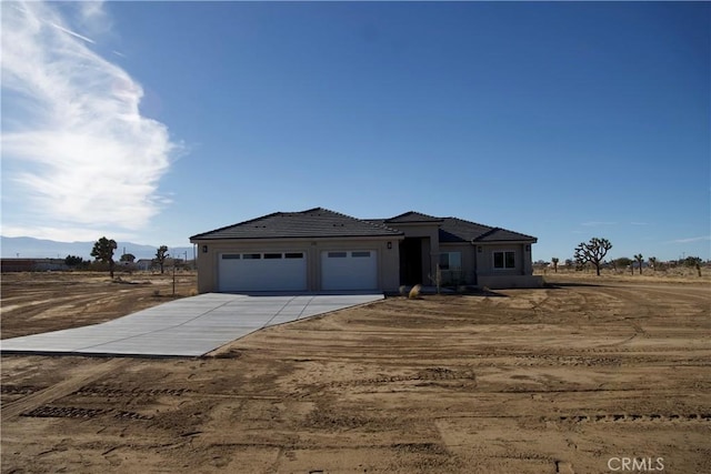 view of front of home featuring a rural view and a garage