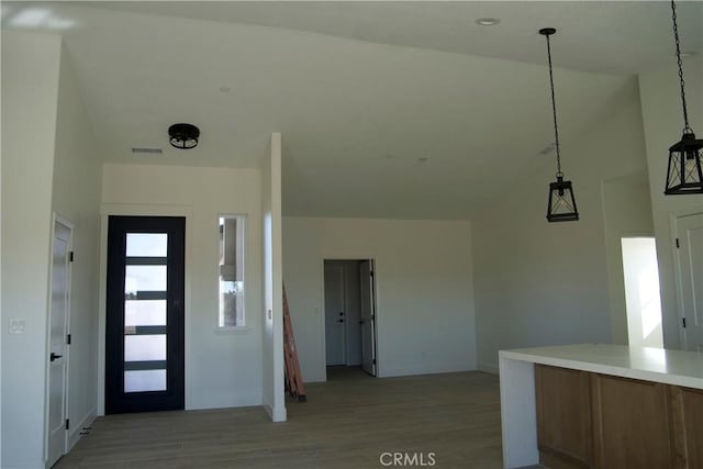 entrance foyer with high vaulted ceiling and light hardwood / wood-style floors