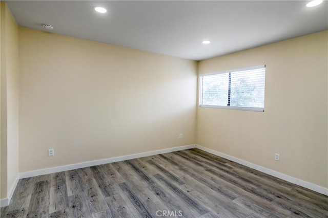 unfurnished room with dark wood-type flooring