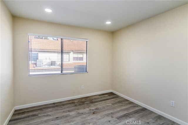 empty room with hardwood / wood-style flooring