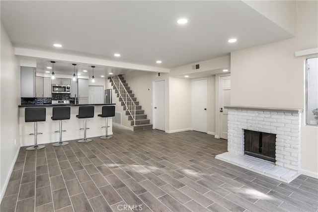 unfurnished living room with a brick fireplace