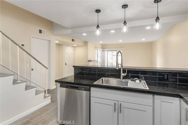 kitchen with dishwasher, sink, and hanging light fixtures