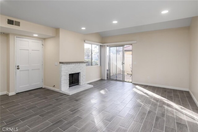 unfurnished living room with a brick fireplace