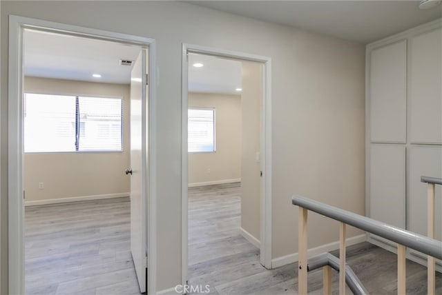 hallway with light hardwood / wood-style flooring