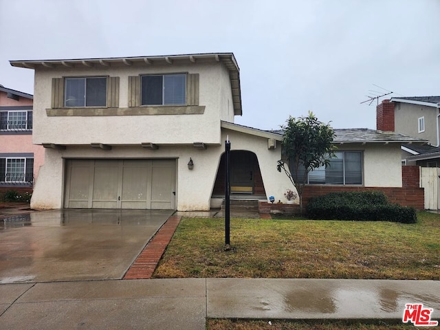 view of front of property with a garage and a front yard