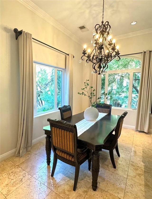 dining room with an inviting chandelier, plenty of natural light, and ornamental molding