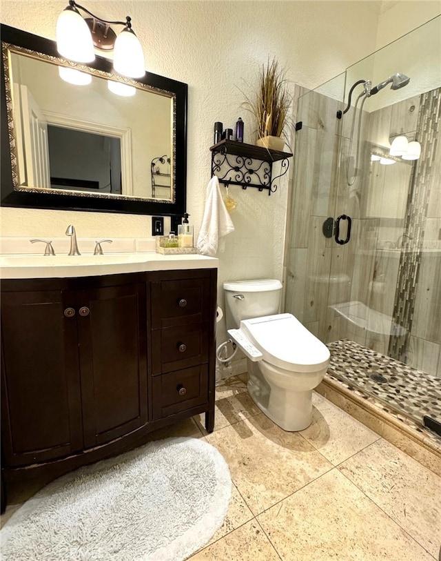 bathroom with vanity, toilet, tile patterned floors, and a shower with shower door