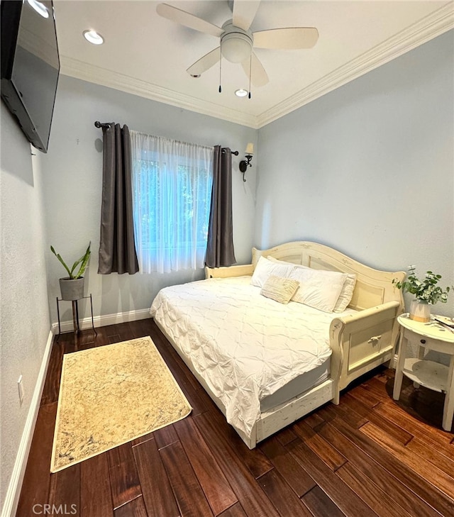 bedroom featuring crown molding, dark wood-type flooring, and ceiling fan