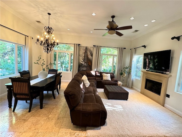 living room featuring crown molding, a healthy amount of sunlight, and ceiling fan with notable chandelier