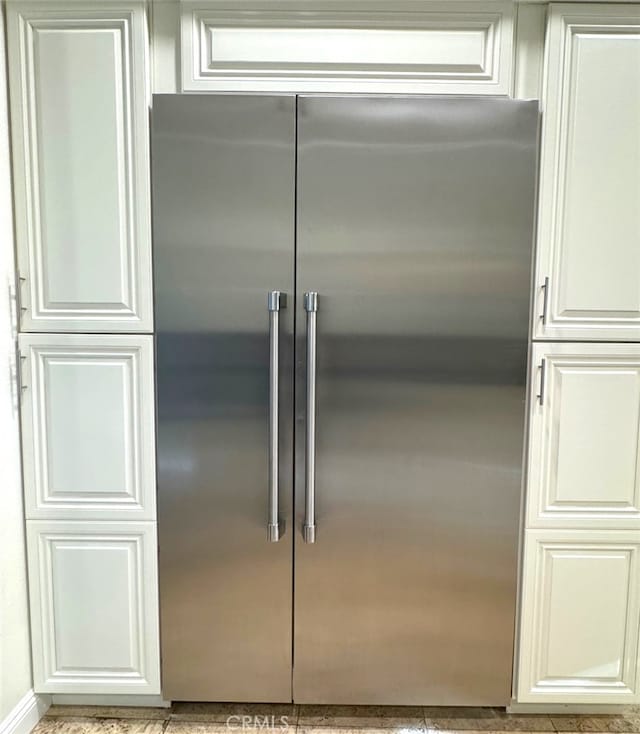 interior details featuring white cabinets and stainless steel built in refrigerator