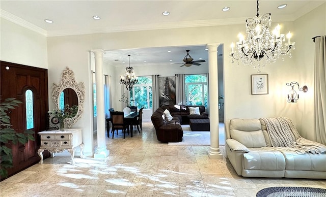 living room with ceiling fan with notable chandelier, ornamental molding, and decorative columns