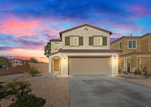 mediterranean / spanish-style home featuring a garage