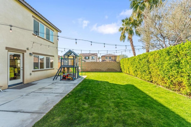 view of yard featuring a playground and a patio