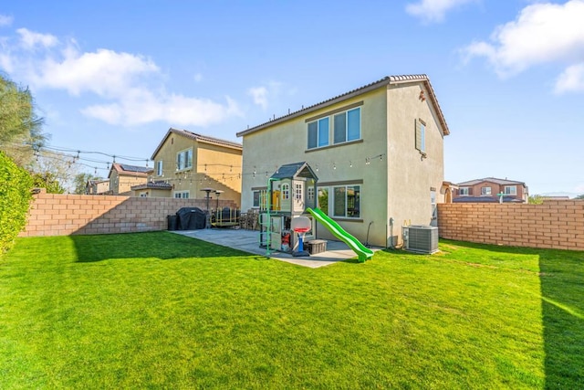 back of property featuring central AC unit, a yard, and a patio area