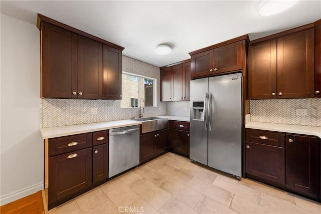 kitchen with sink, decorative backsplash, dark brown cabinets, and stainless steel appliances