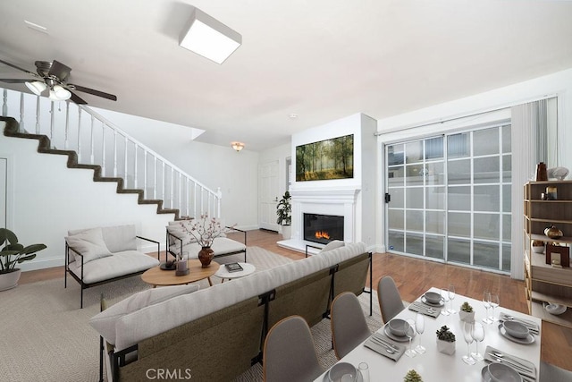 living room featuring ceiling fan and light wood-type flooring