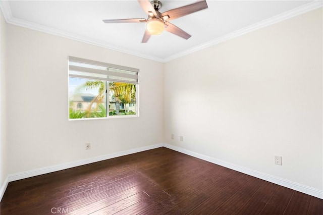 spare room with dark hardwood / wood-style flooring, ornamental molding, and ceiling fan