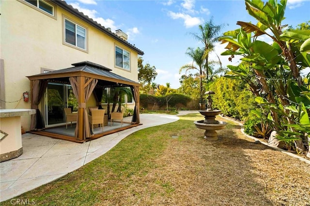 view of yard featuring a gazebo and a patio