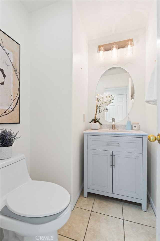 bathroom featuring vanity, tile patterned floors, and toilet