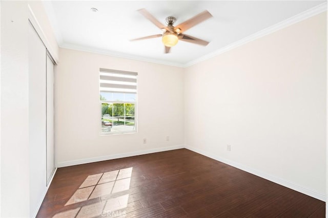 unfurnished room featuring dark hardwood / wood-style flooring, ornamental molding, and ceiling fan