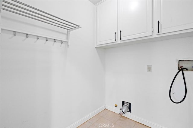 laundry room with cabinets, washer hookup, and light tile patterned floors