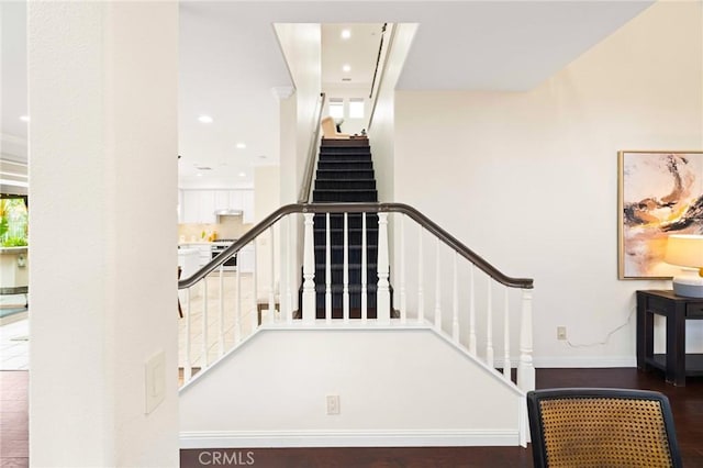 staircase with hardwood / wood-style floors