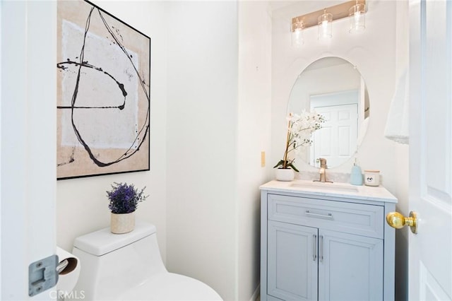 bathroom featuring vanity and toilet