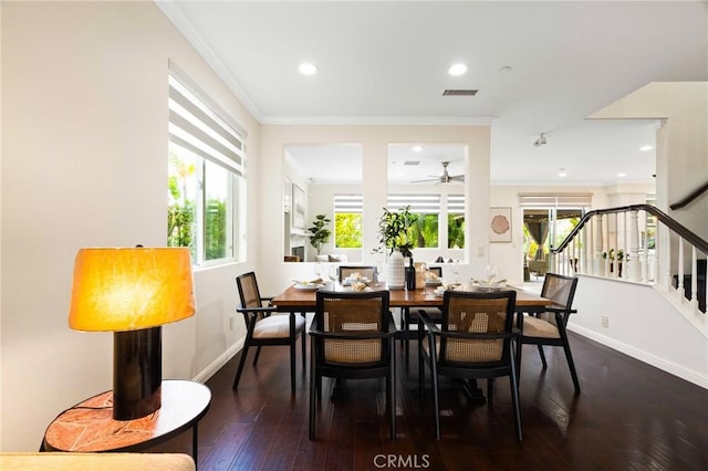 dining room featuring dark wood-type flooring and ornamental molding