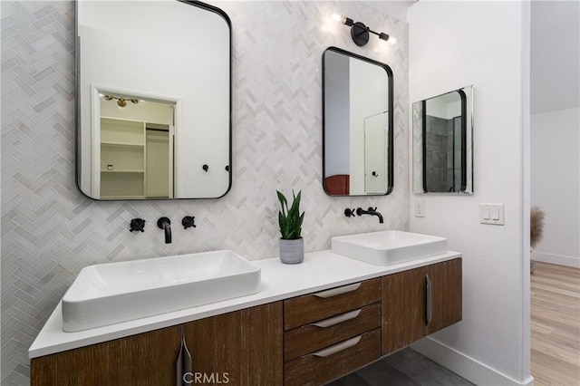 bathroom with tasteful backsplash and vanity